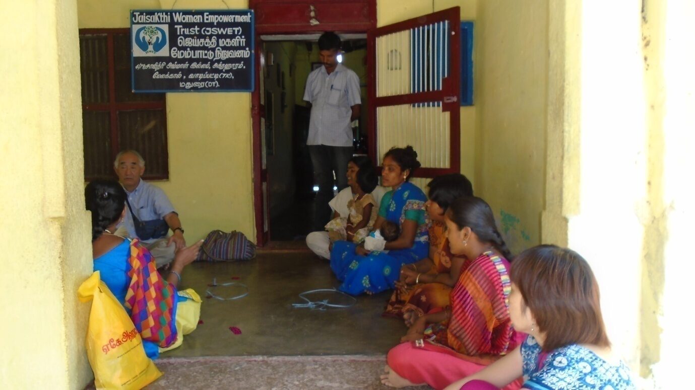 A JSWET-trained woman working at her sewing machine at home